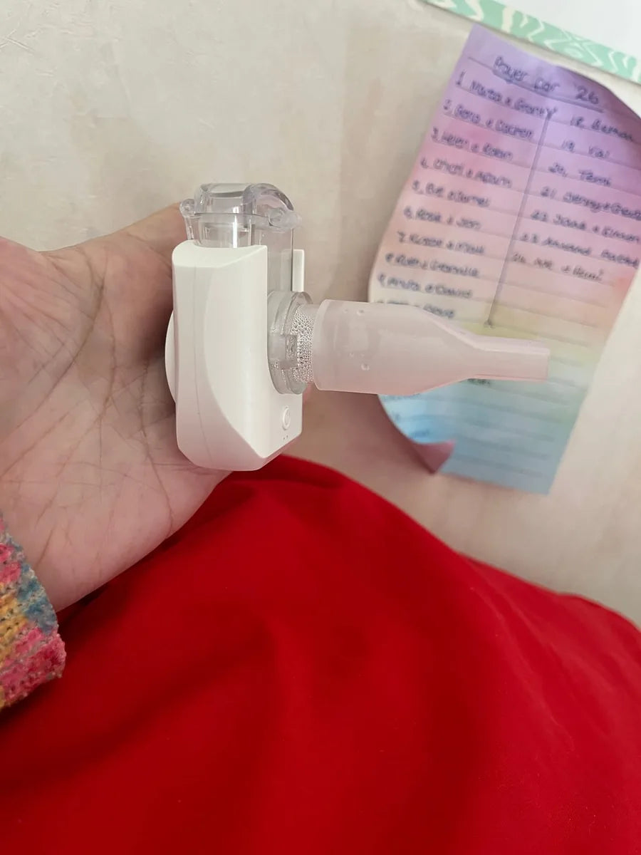 Portable nebulizer held in a hand