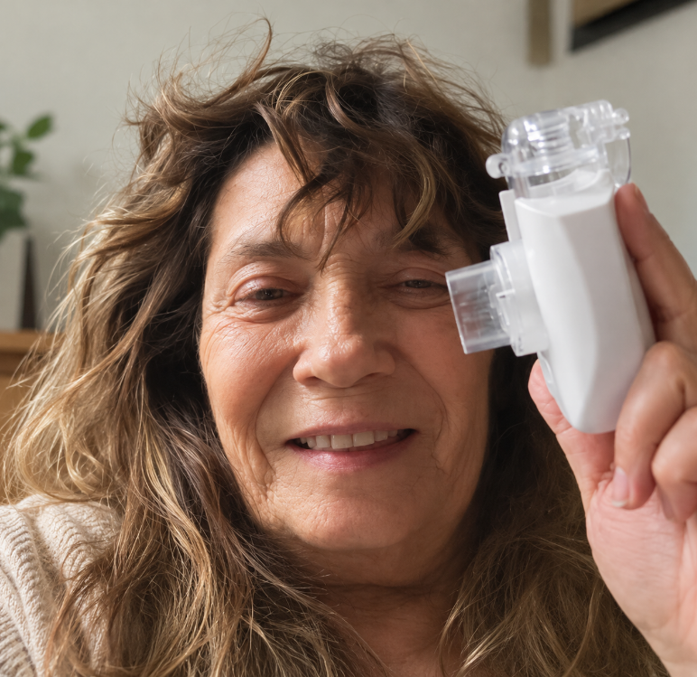 Patricia K. using a portable nebulizer